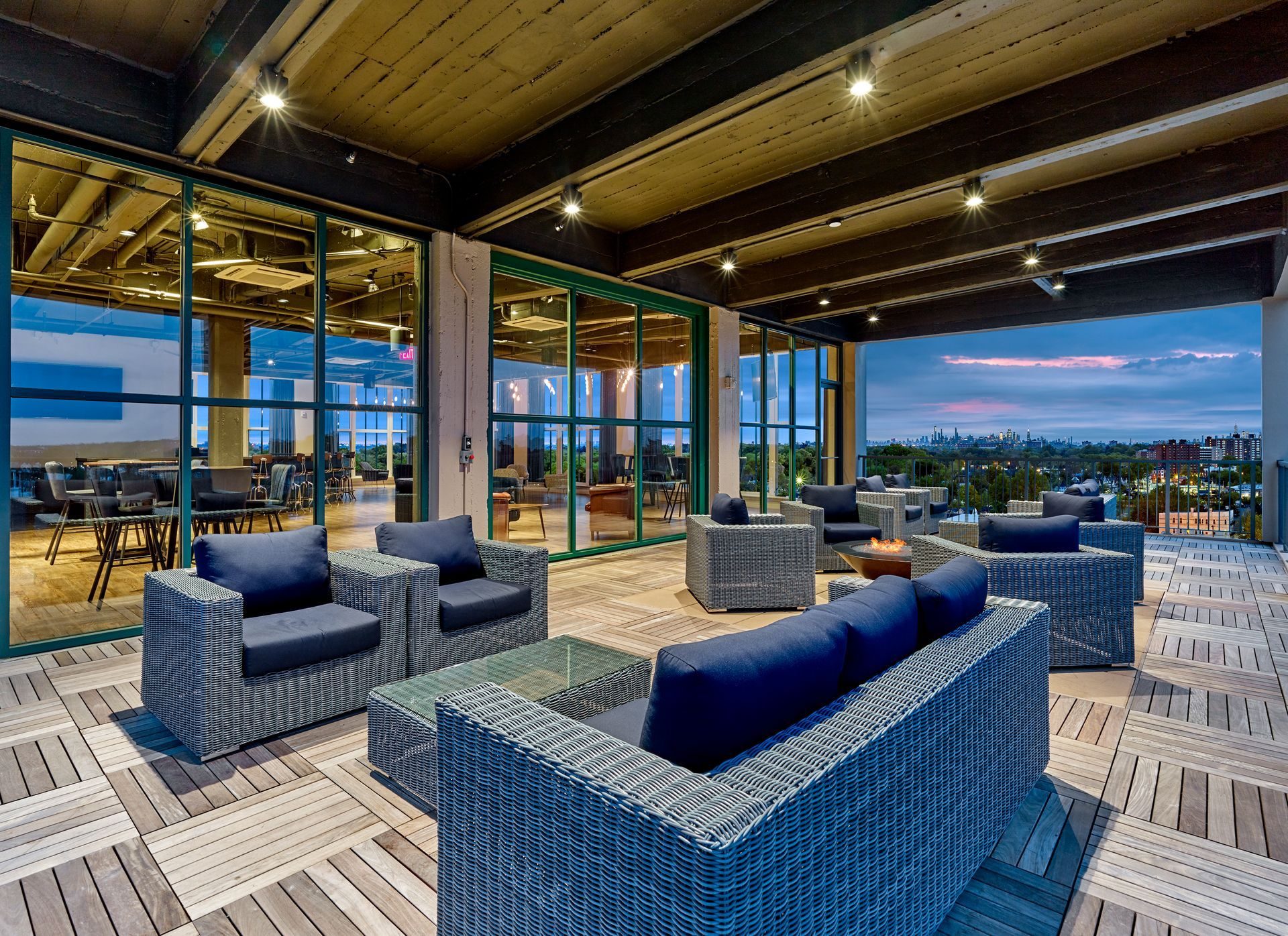 A living room with a couch, table, chairs and a television.